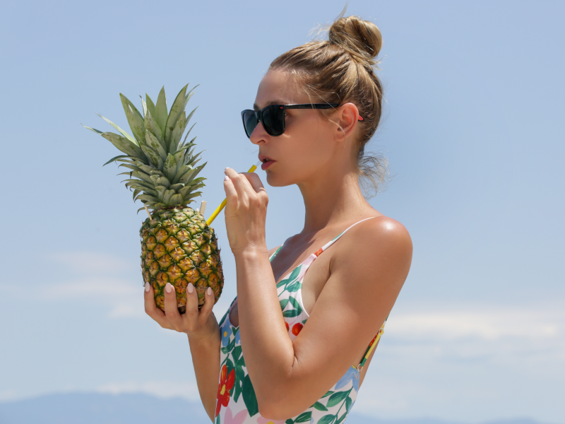 Woman drinking pineapple juice