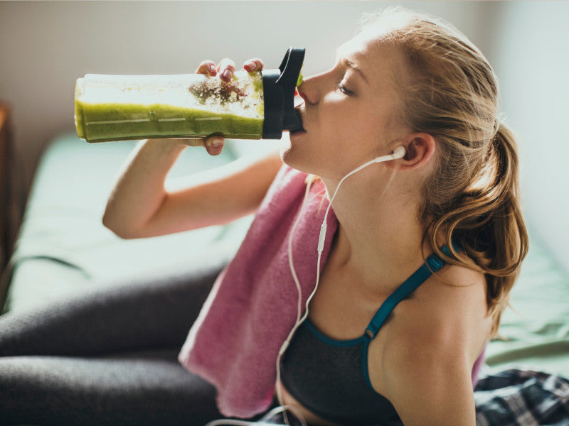 woman drinking meal shake