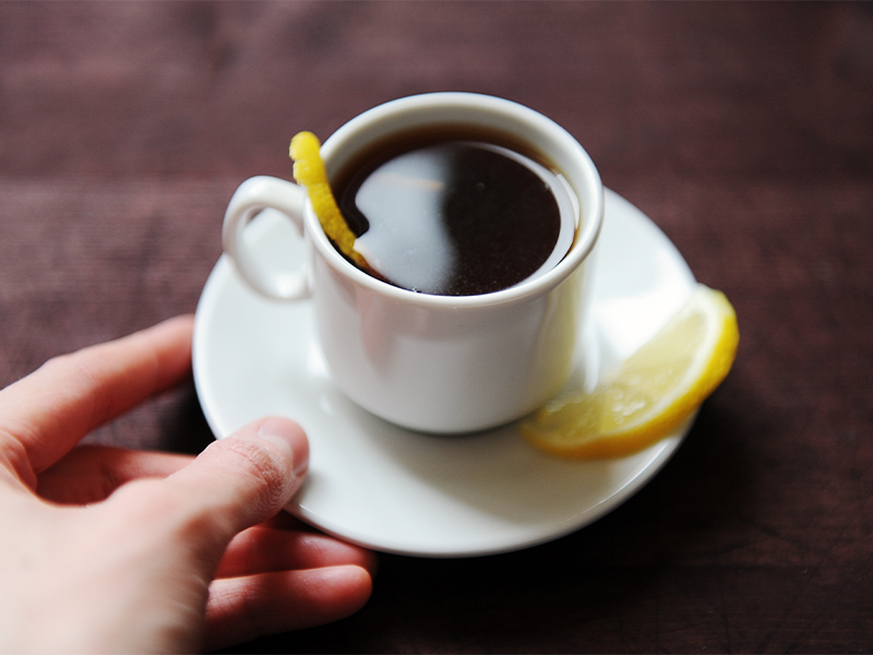 Cup of coffee with lemon