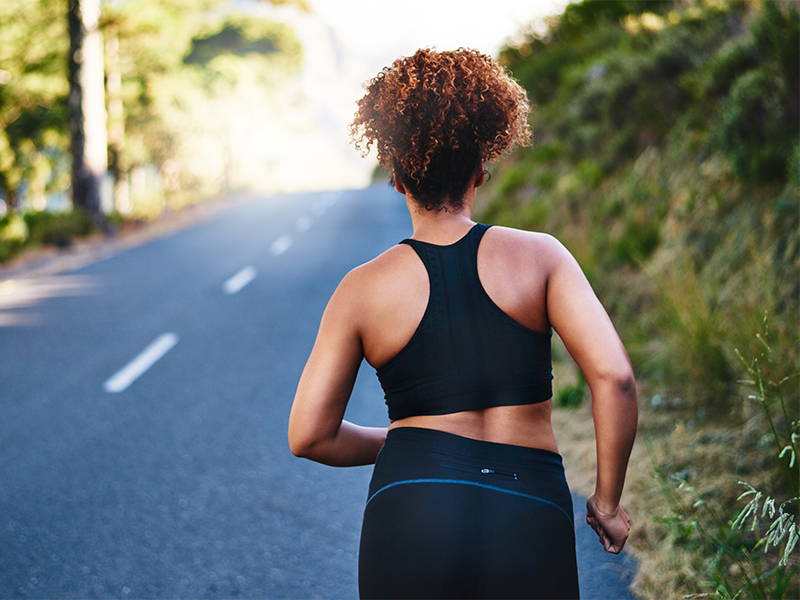 Woman running on road to get cardio