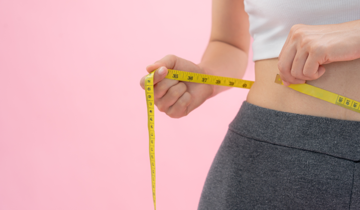 woman measuring waist