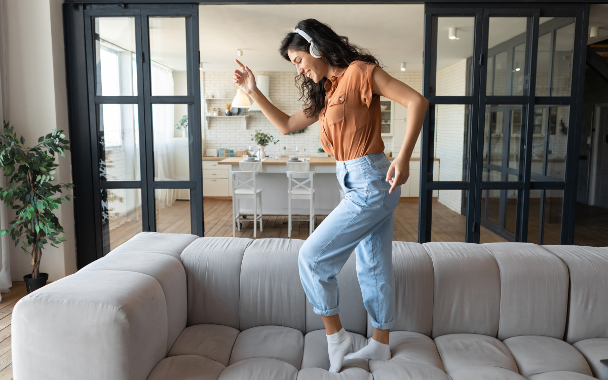 Woman dancing on sofa