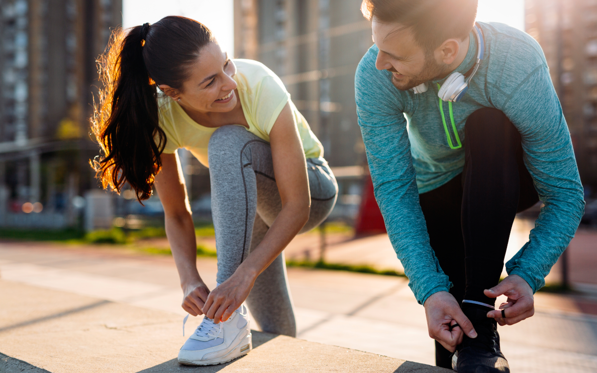 man and woman preparing to go for a run