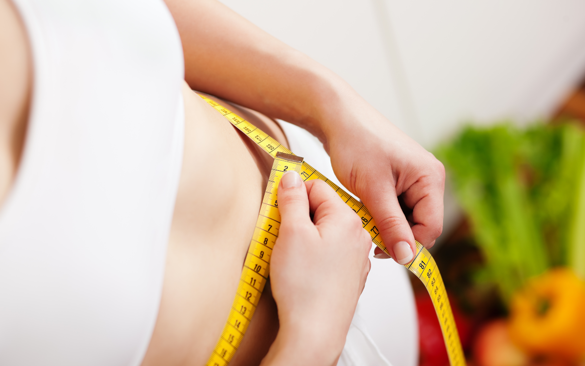 woman measuring waist