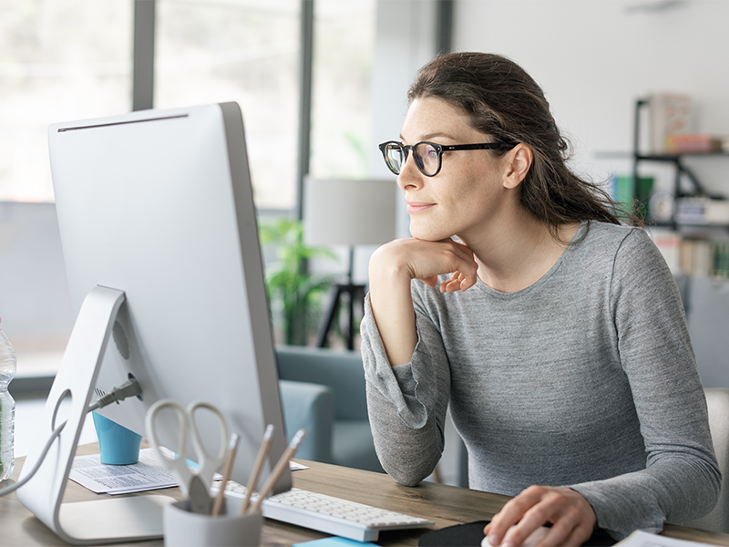 Woman sat at desk working after drinking water to help with weight lose