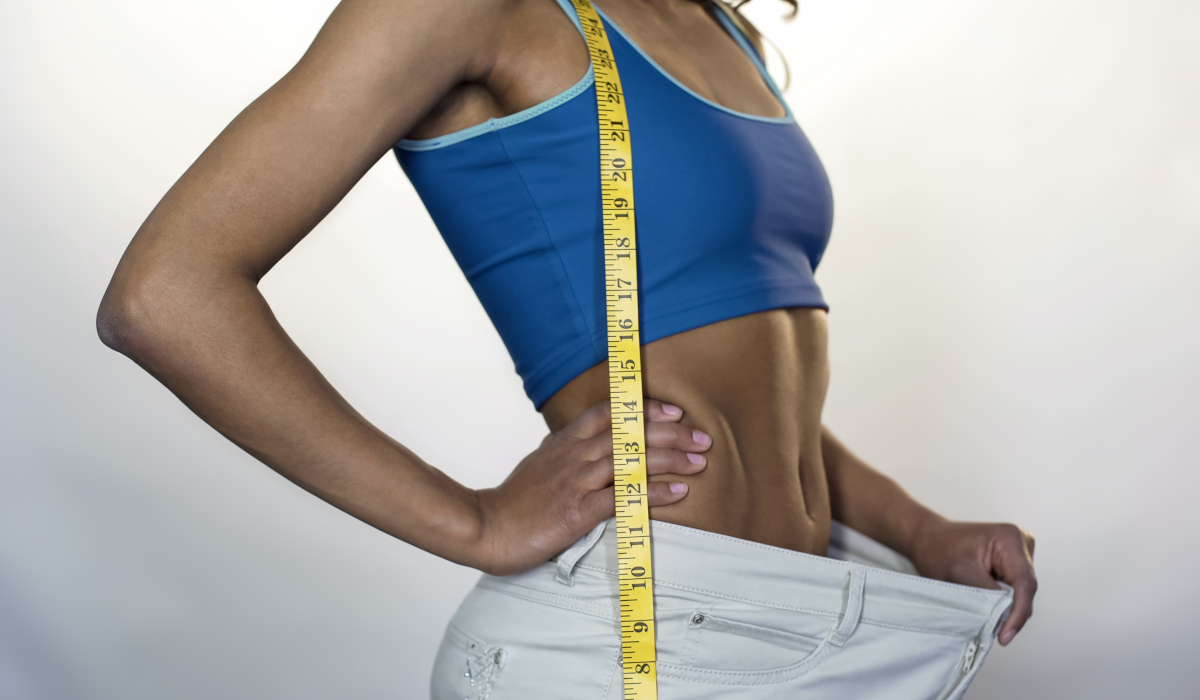 woman in baggy trousers after losing weight