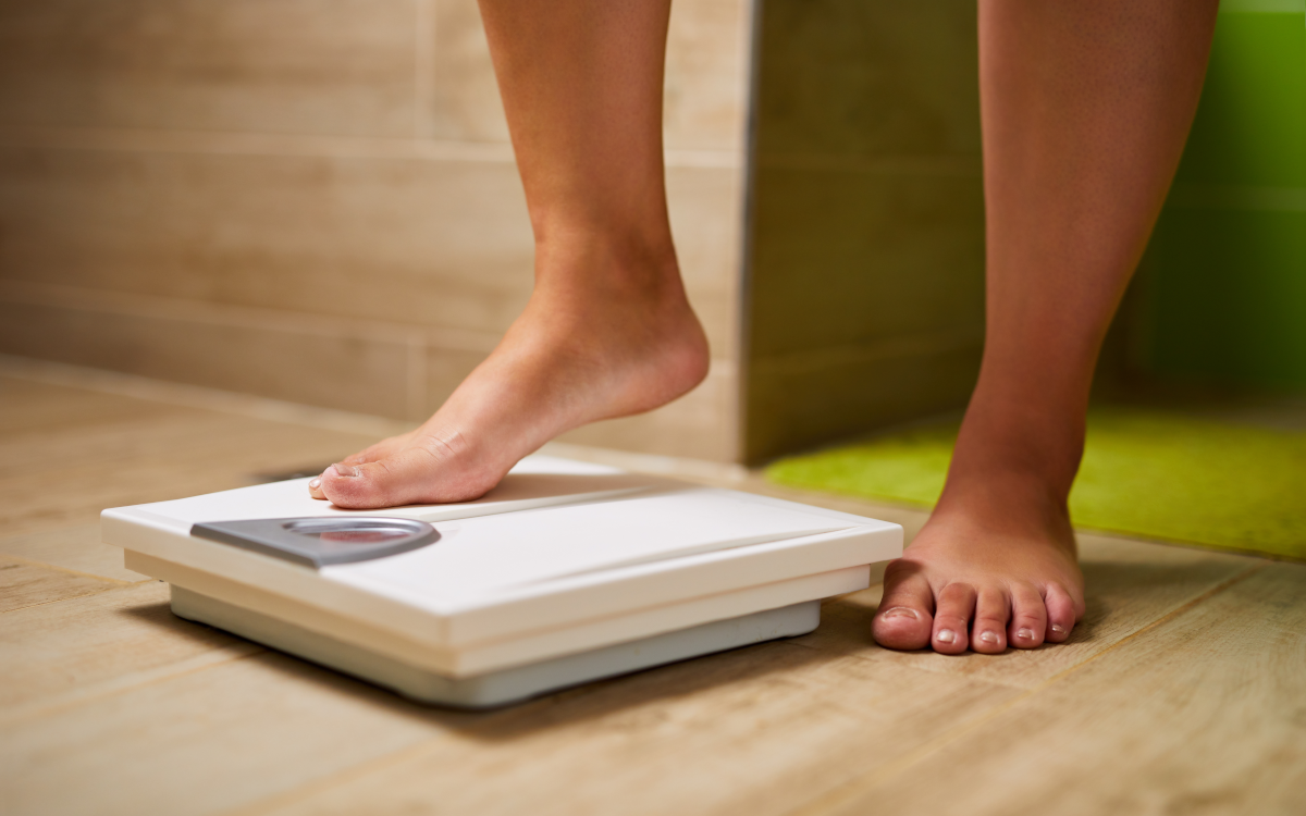 Woman on body weight scales