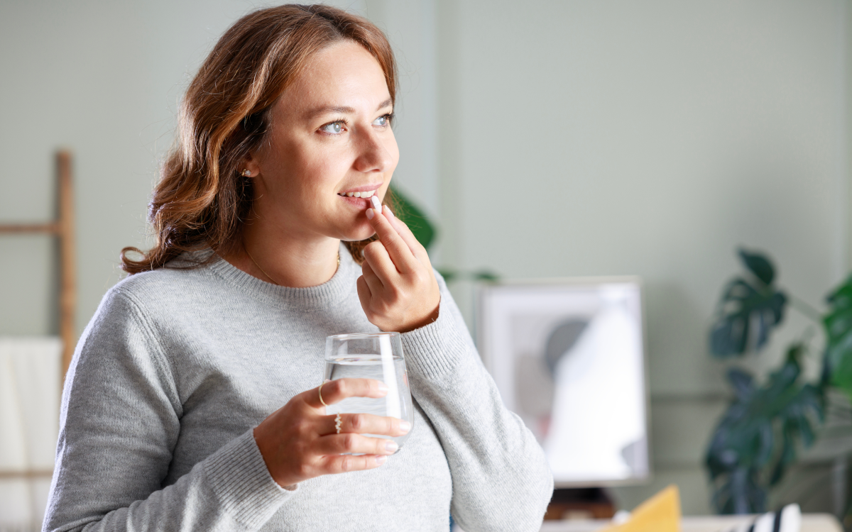 Woman taking DMAE pill