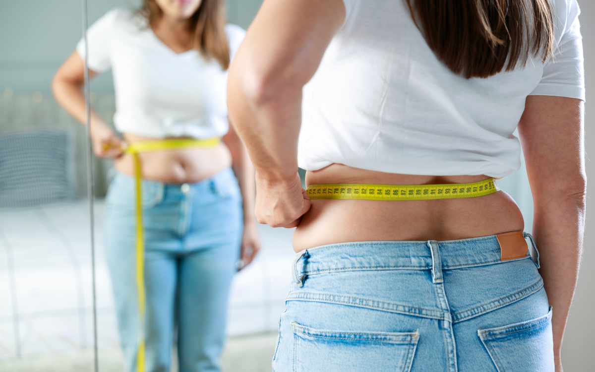 Woman measuring waist