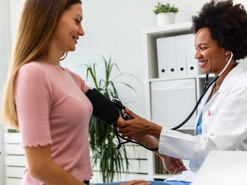 Doctor checking blood pressure