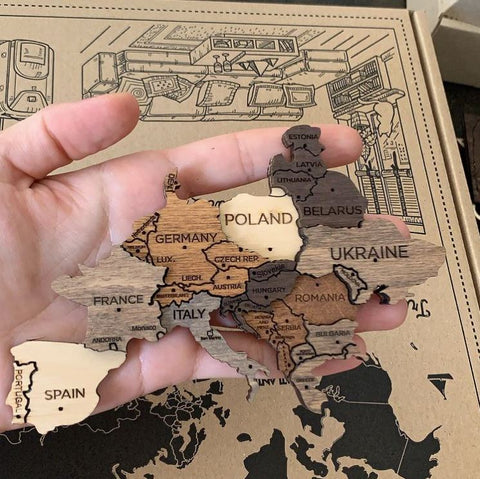 Showing the pieces of a 3D Wooden World Map in Multicolor