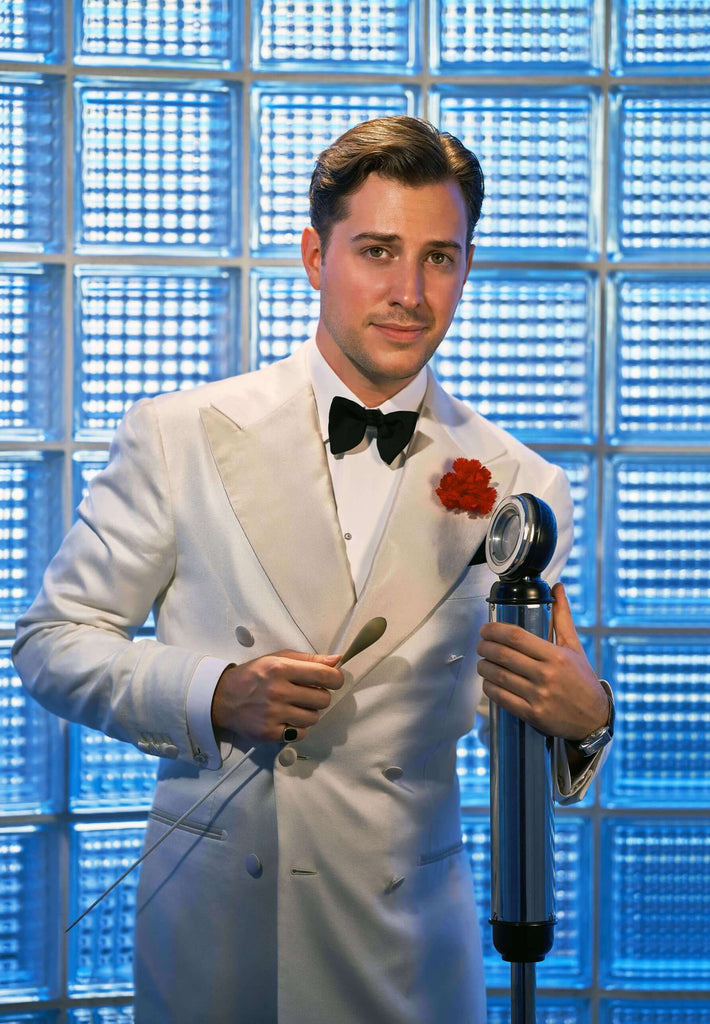 Alex Mendham mit weißem Dinnerjacket und roter Her von Welt Boutonnière (rote Nelke aus Seide für das Knopfloch)