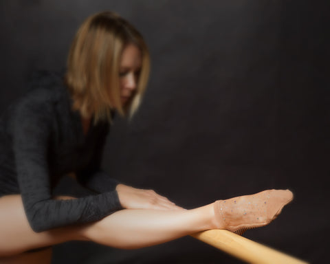 Woman at barre class wearing nude Shashi grip socks with sparkle