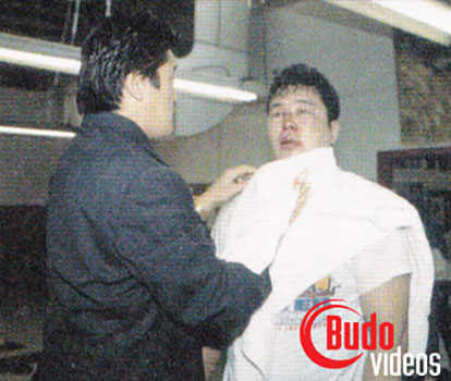 Yoji Anjo getting blood wiped off his face