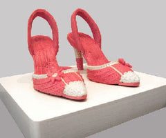 Pair of high heel shoes made of pink bubble gum