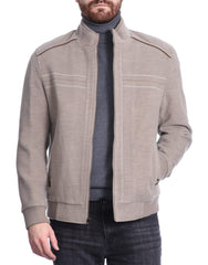Man wearing a stylish grey/beige bomber jacket over grey turtleneck