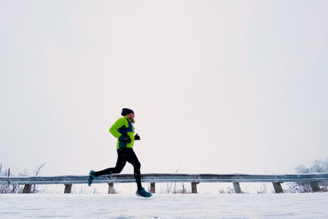 Person running along a bridge in the winter