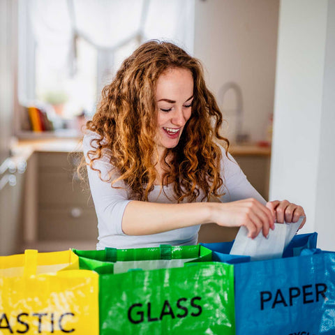 Girl happily recycling