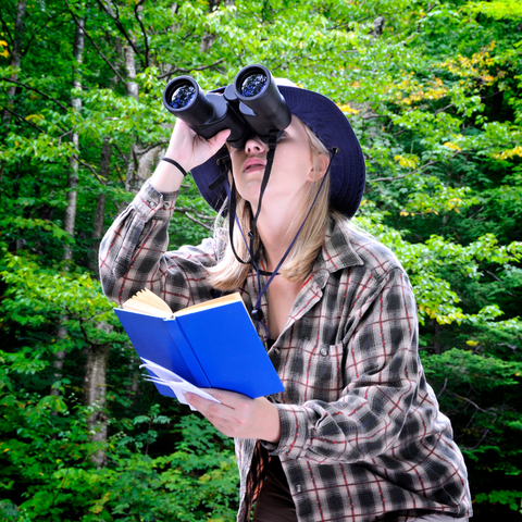 Gifting outdoor Experiences as an Eco Easter gift. Woman birdwatching.