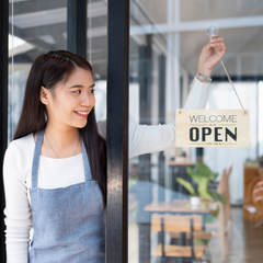 Woman opening shop. Support local business.