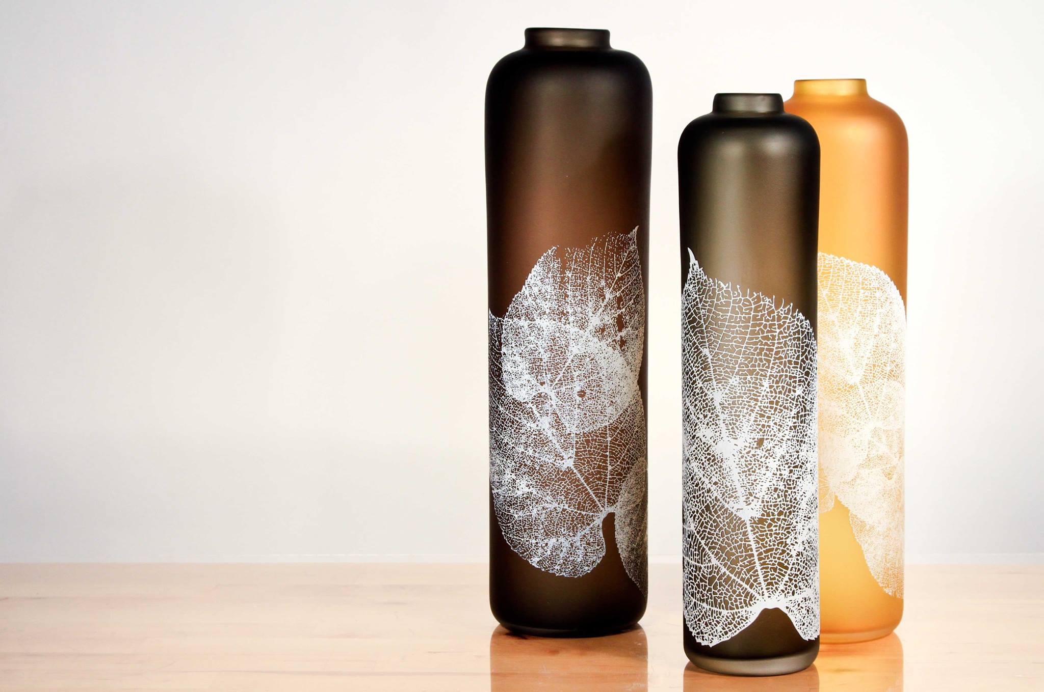 Glass vessels with sandblasted leaf detail by Nick Chase