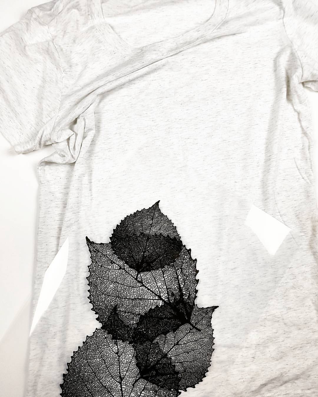 Women's shirt with transparency of leaves against it 