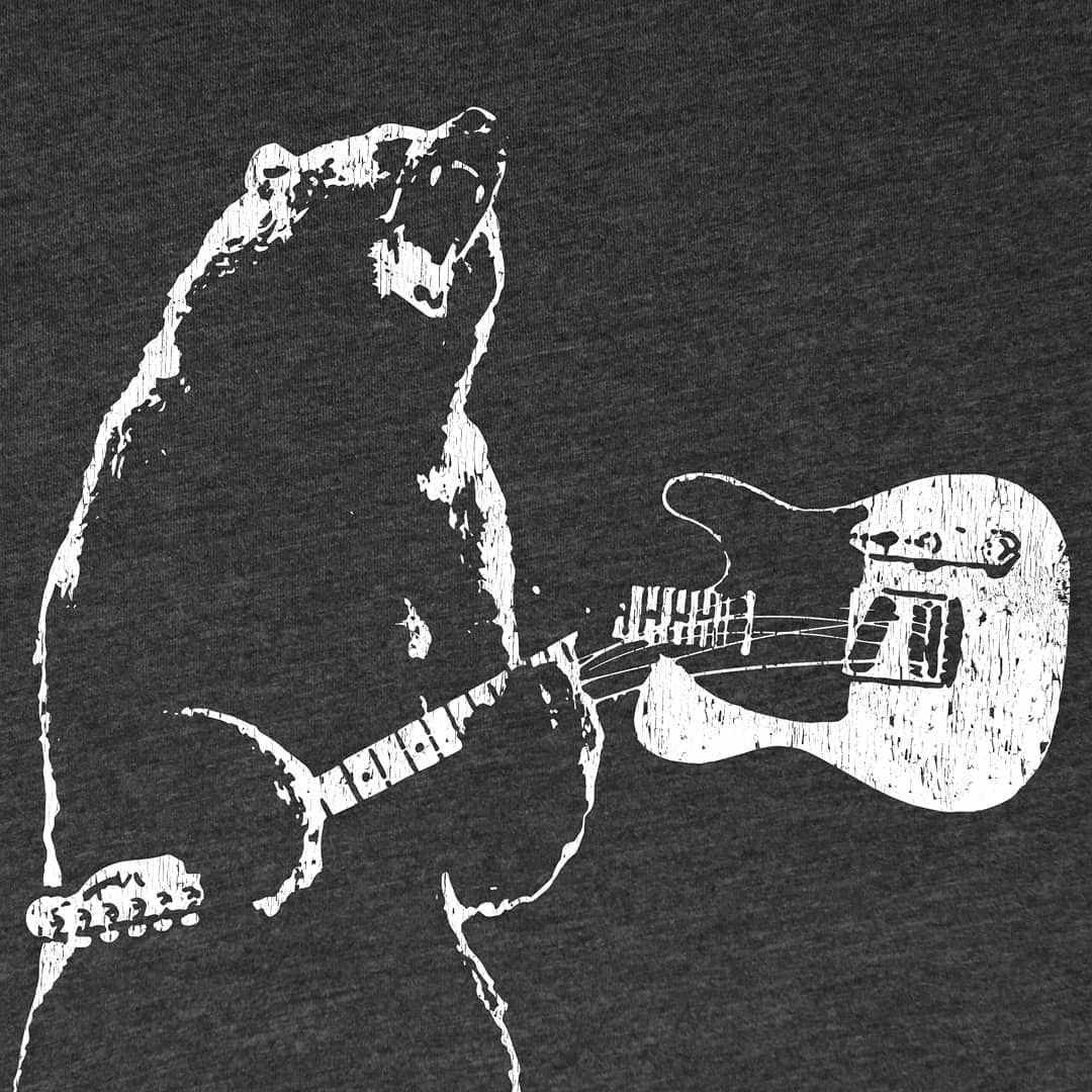 Close up graphic design of a bear holding a guitar