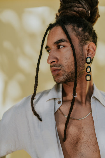 a male model with dreadlocks posing for a photo 