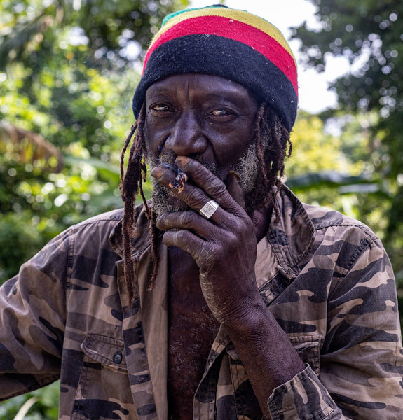 a man in a beanie smoking a marijuana cigarette