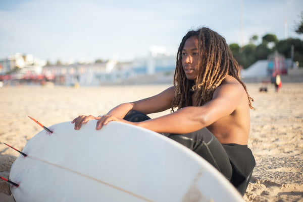 A man with a surfboard at the beach