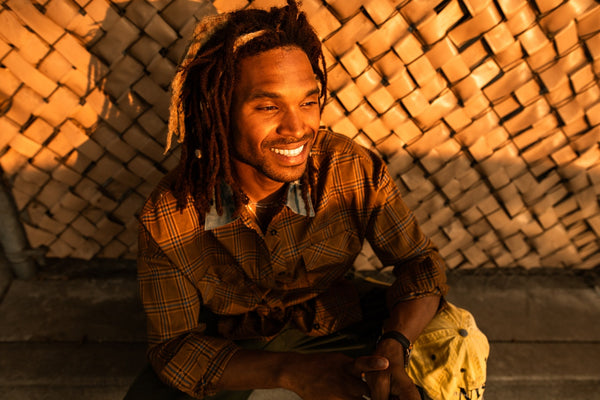 a happy man with dreads smiling 