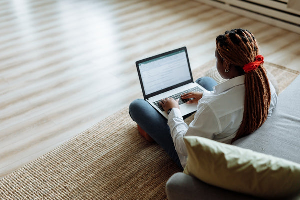 a woman with dreadlocks typing on a computer