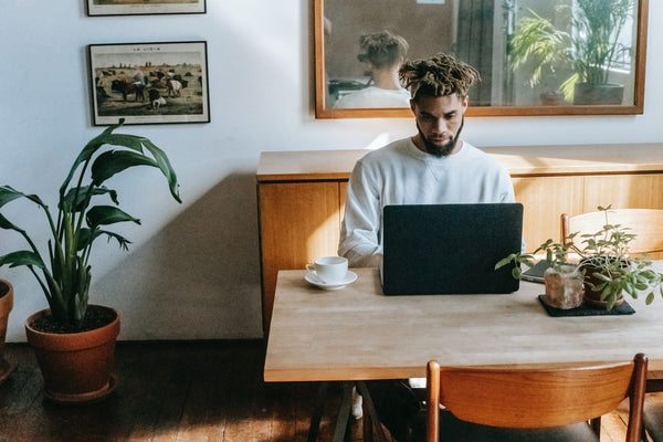 a man with dreadlocks using a laptop