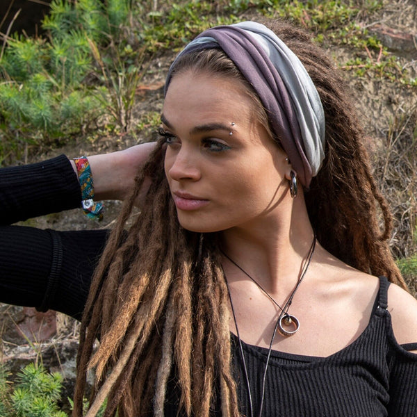 a woman with her dreadlocks in a headwrap