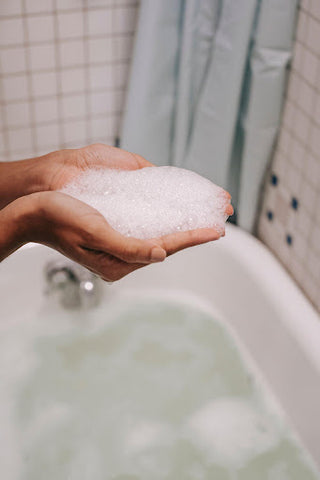 Person with handful of soap suds