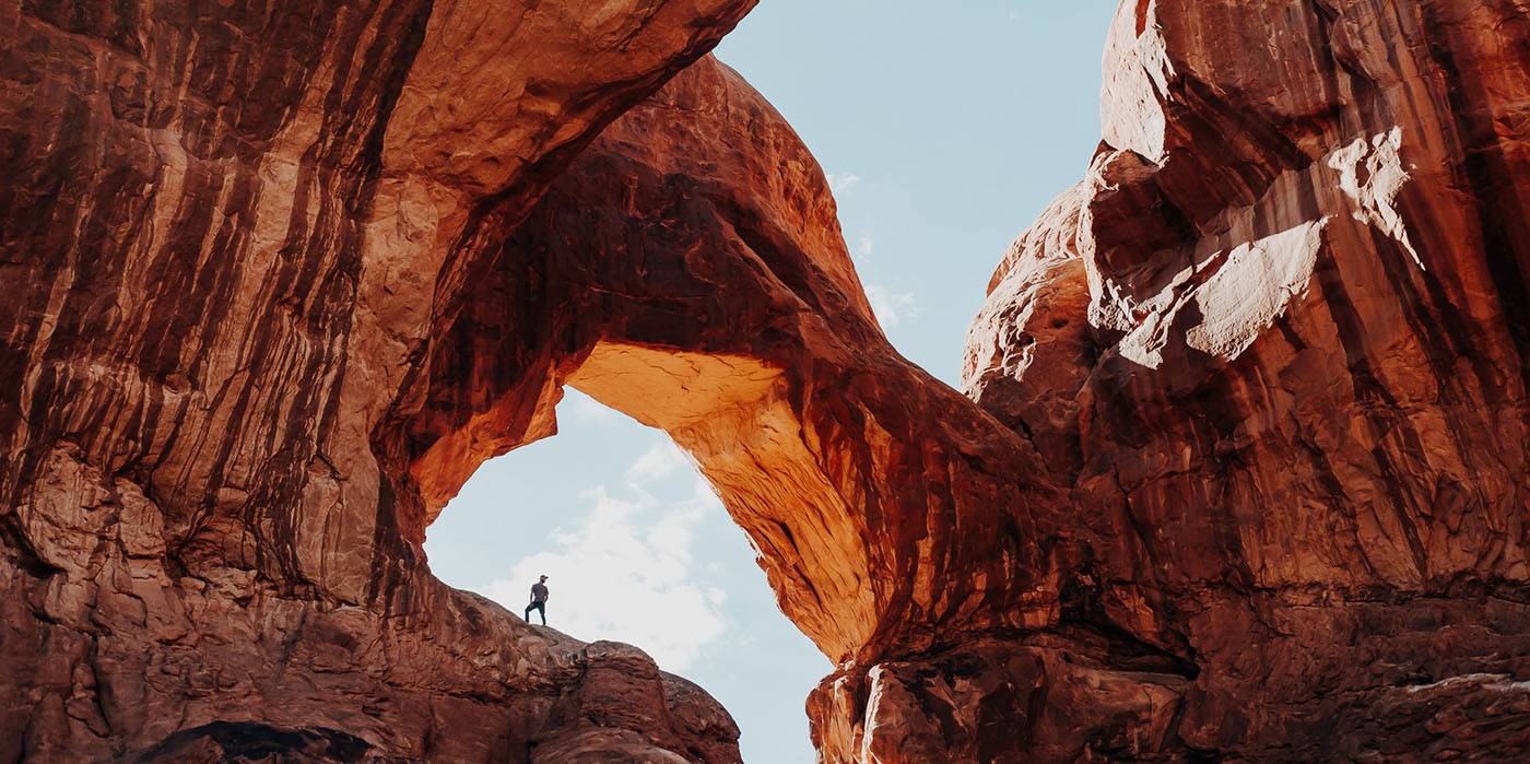 Man standing on giant rock structure