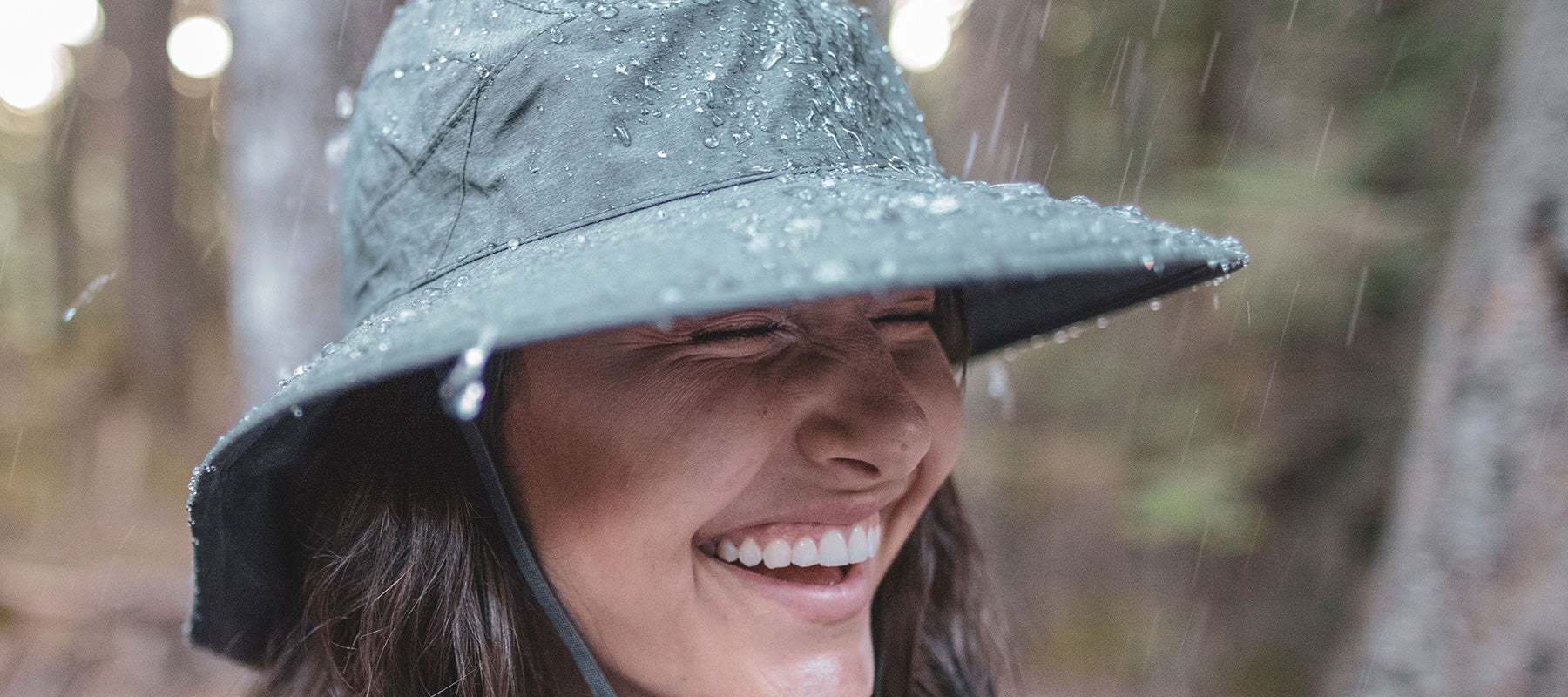 Woman with rain beading off hat