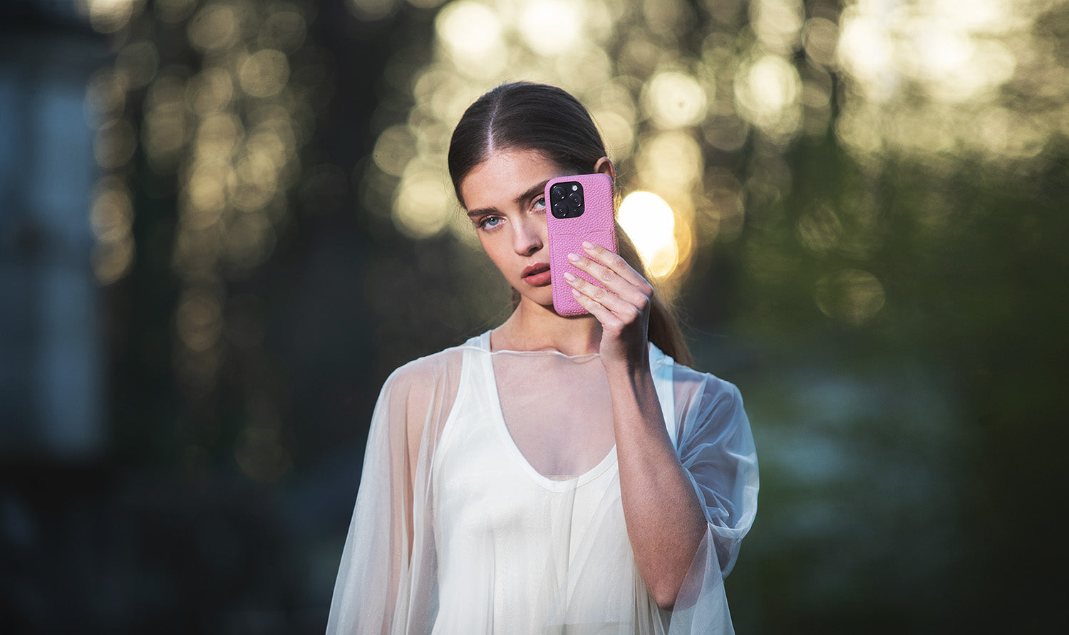 A stylish woman protects her iPhone with the best leather case.