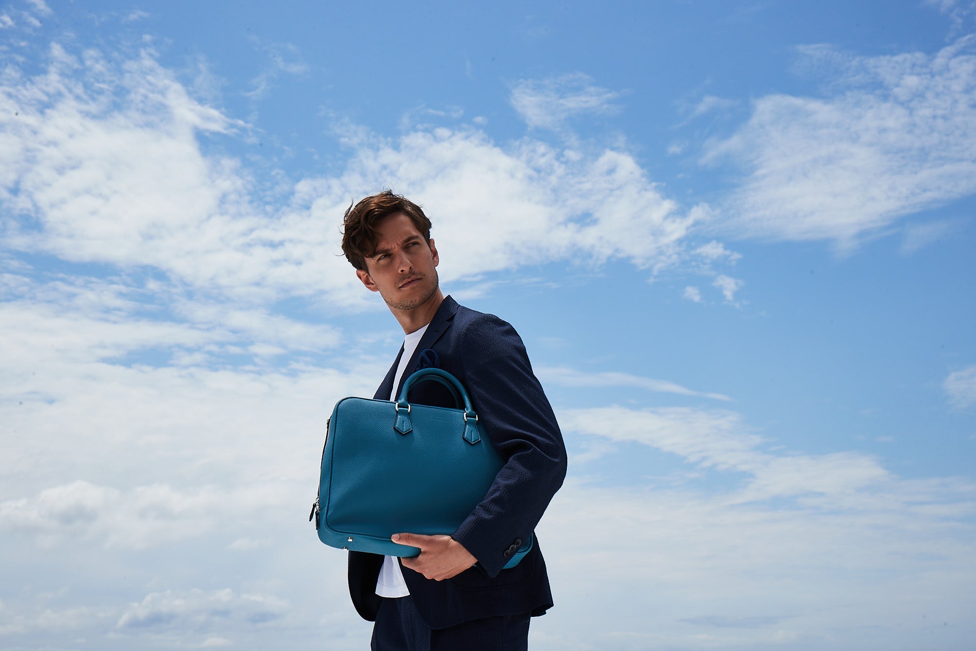 A stylish man carries a BONAVENTURA leather briefcase Jackson on his way to the office.