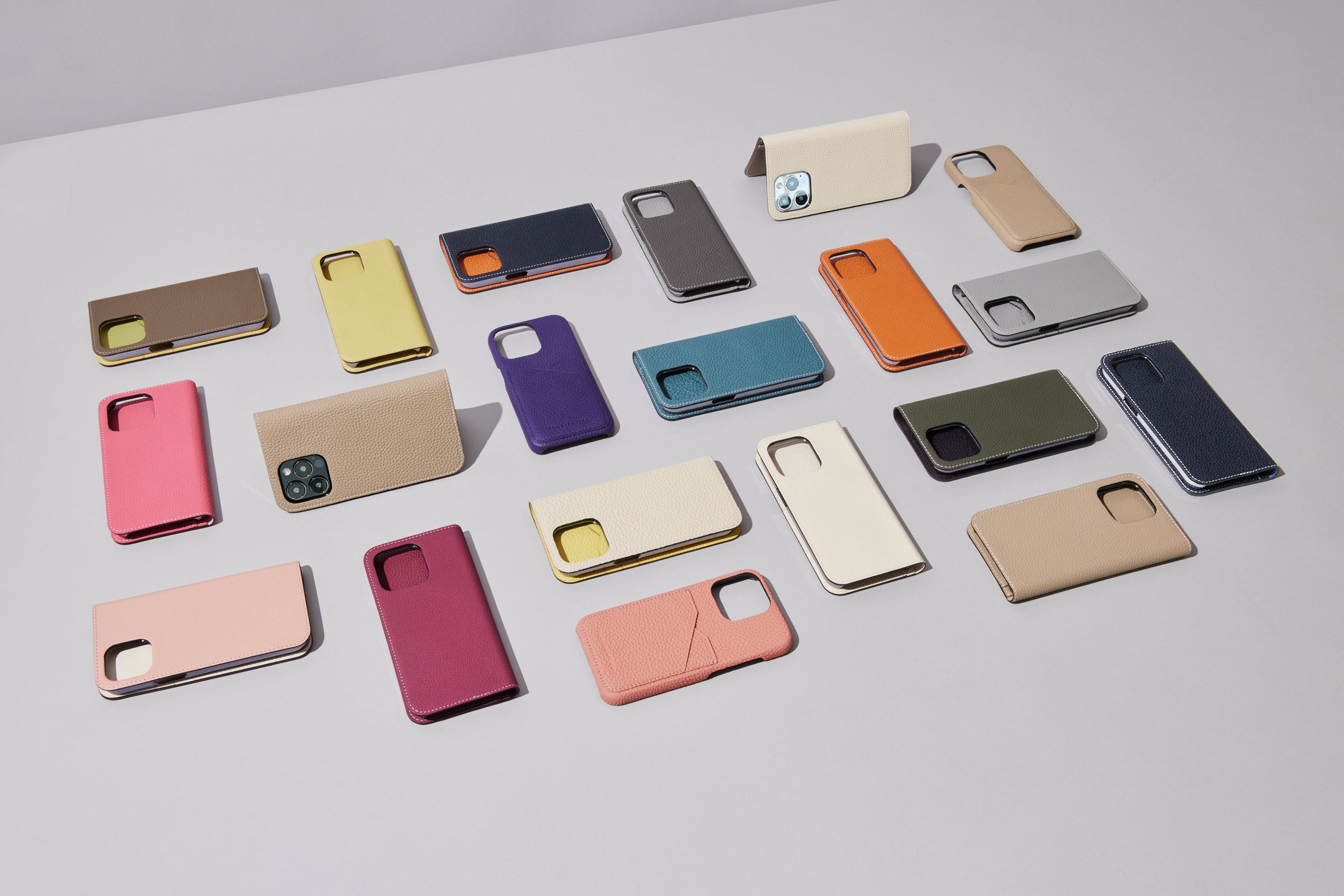 Various BONAVENTURA leather cases for iPhone 15 on an elegant background.