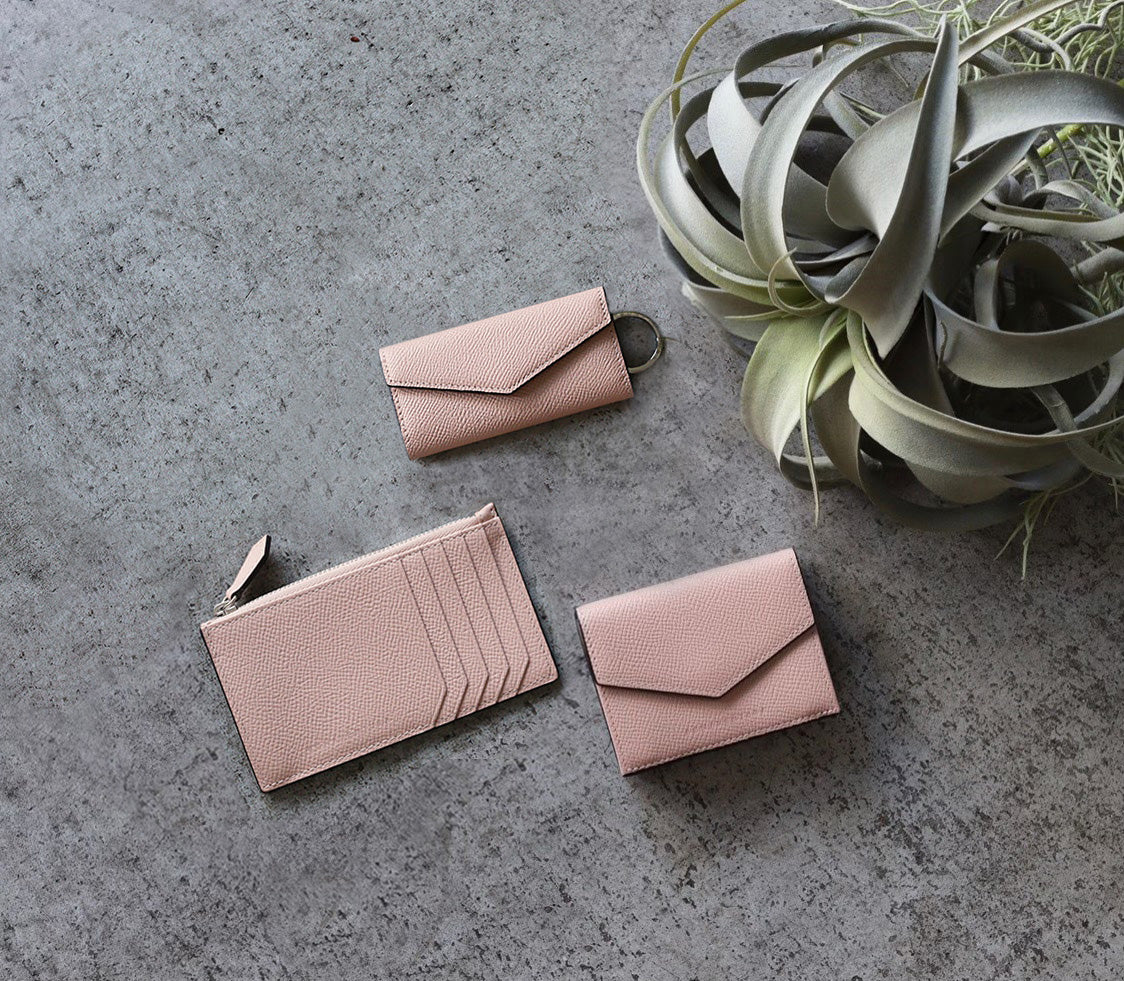 Stylish pastel-colored leather accessory on a light surface