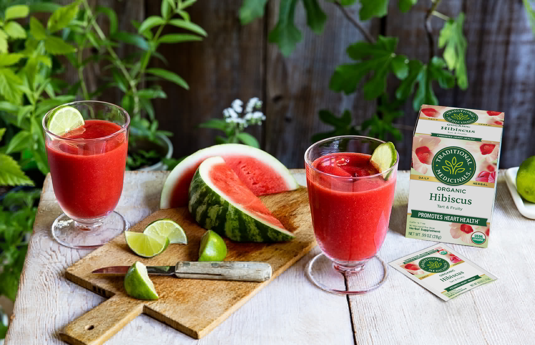 Watermelon, daiquiris in glasses, and Hibiscus Tea box on table