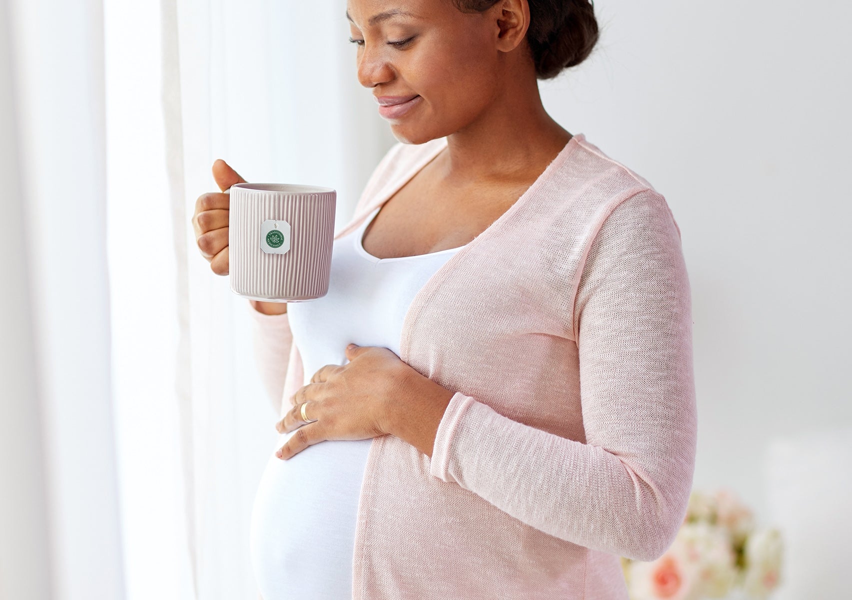 Pregnant Woman Holding Cup of Organic Pregnancy Tea