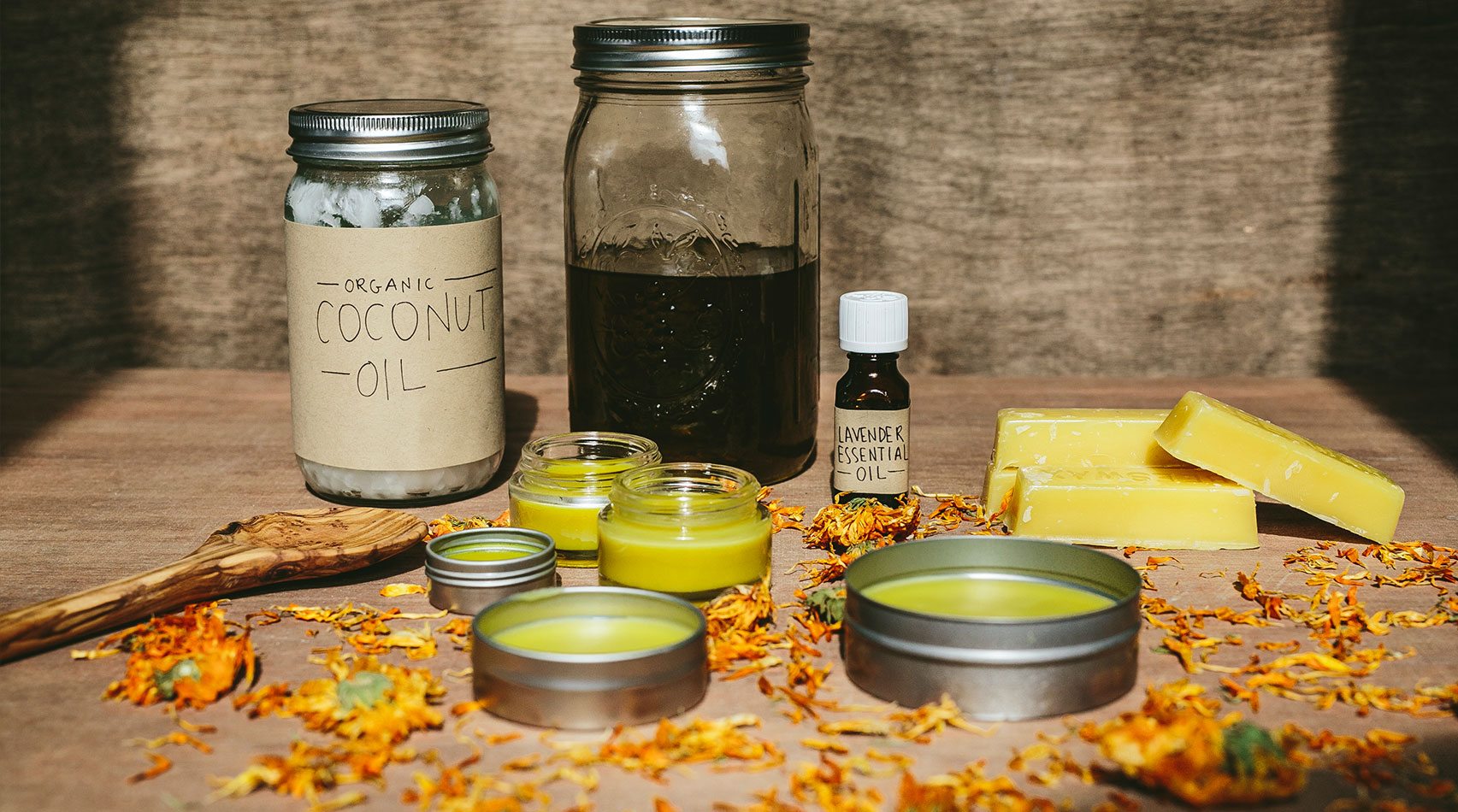 Coconut oil and Lavender essential oil jars with salves in foreground