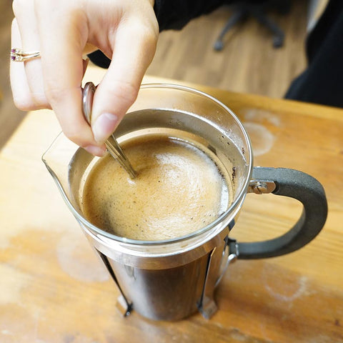 Stirring coffee in French press to make cold brew coffee
