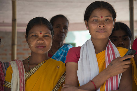 Female tea workers stand together