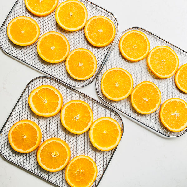Fresh orange slices arranged on a tray, ready for dehydration, to be used as natural orange decoration in our handmade soaps.