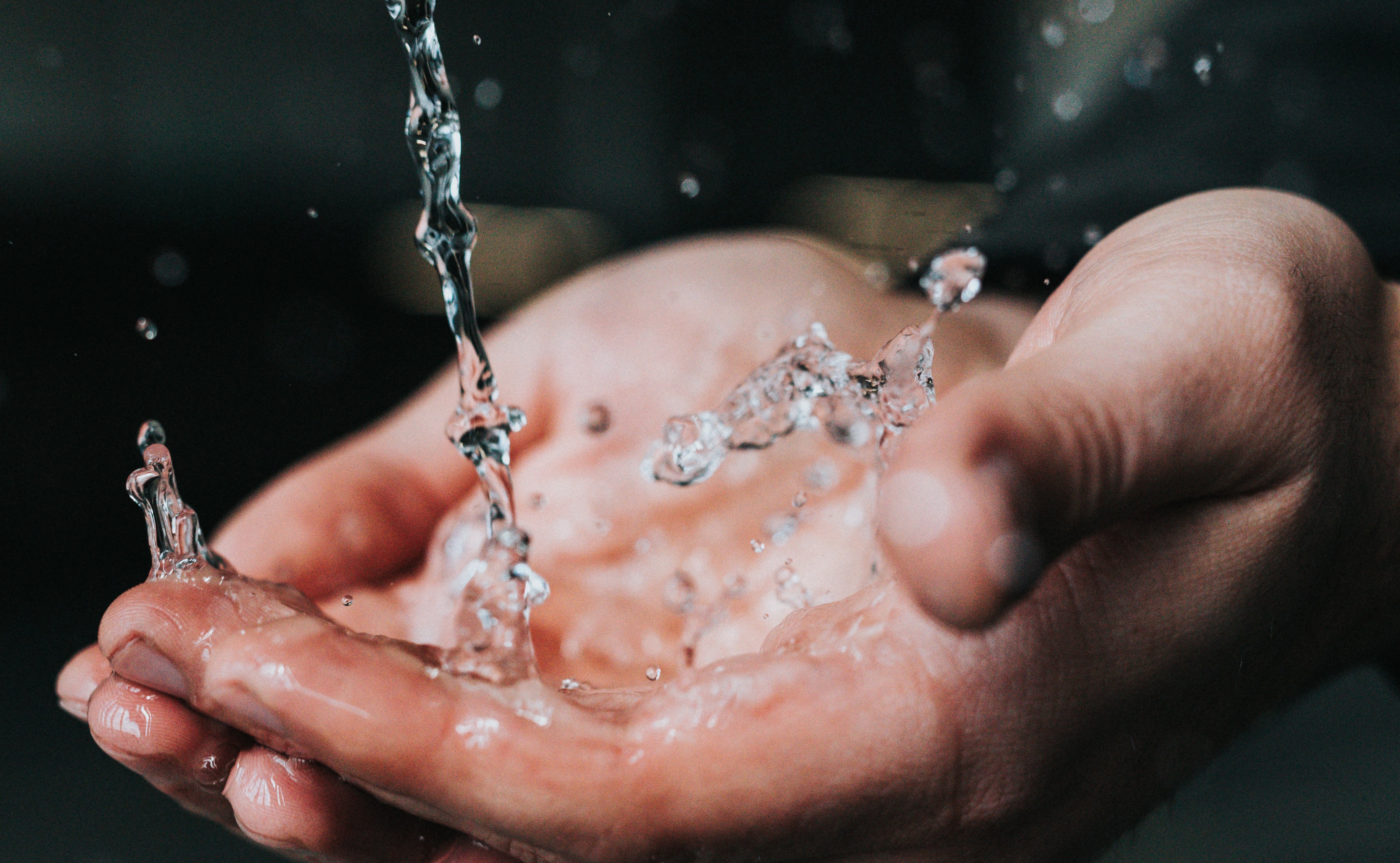 Water Splashing into Cupped Hands