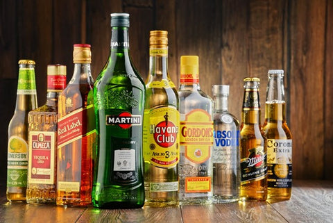 How Does Alcohol Work? Many liquor bottles all full with different brands of alcohol.