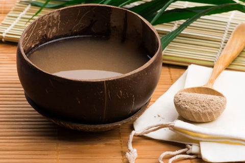 How Are Kava Preparations Made? Wooden bowl and spoon containing Kava.